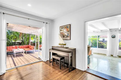 a living room with furniture and a floor to ceiling window