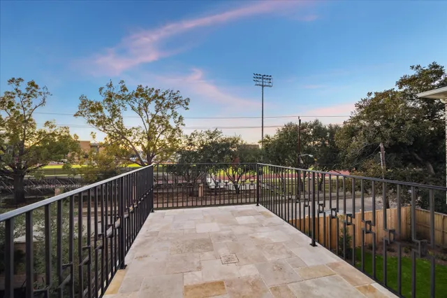 a view of a balcony with wooden fence