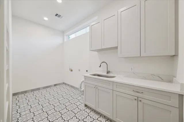 a kitchen with a sink and cabinets