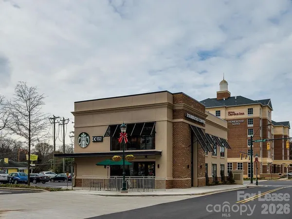 a couple of cars parked in front of a building