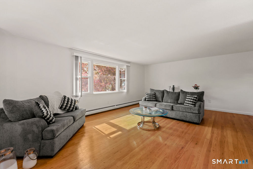 142 Wolcott Hill Road Wethersfield, CT 06109 - Photo 5 of 29 a living room with furniture and a window