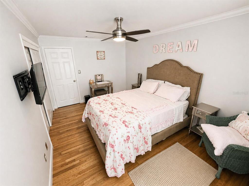 2313 Southeast 7th Street Ocala, FL 34471 - Photo 23 of 54 a bedroom with a bed and wooden floor