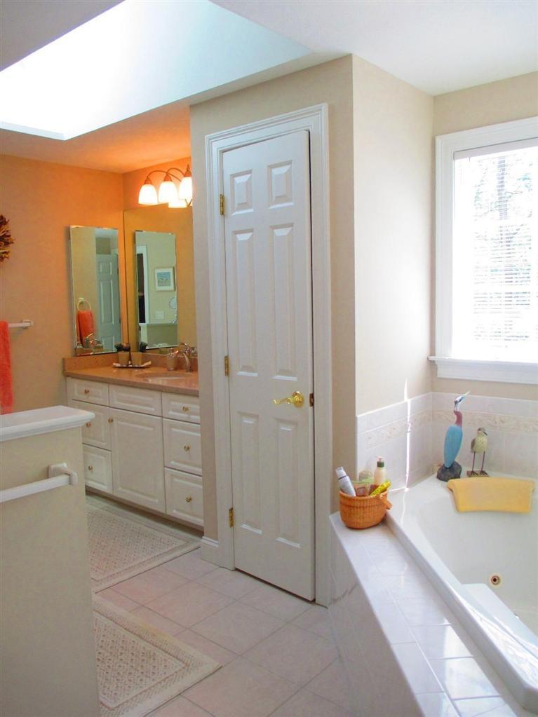 95 Cairn Ridge Road East Falmouth, MA 02536 - Photo 17 of 33 a spacious bathroom with a tub sink and mirror