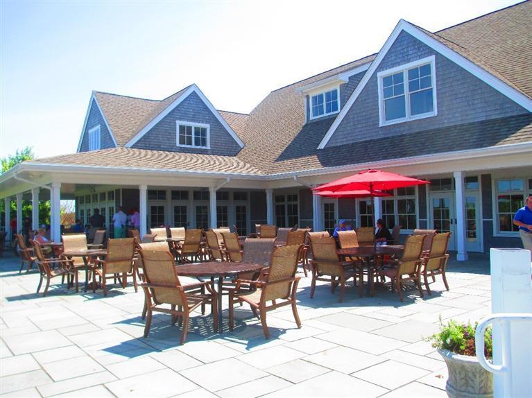 95 Cairn Ridge Road East Falmouth, MA 02536 - Photo 27 of 33 a patio with a table and chairs under an umbrella
