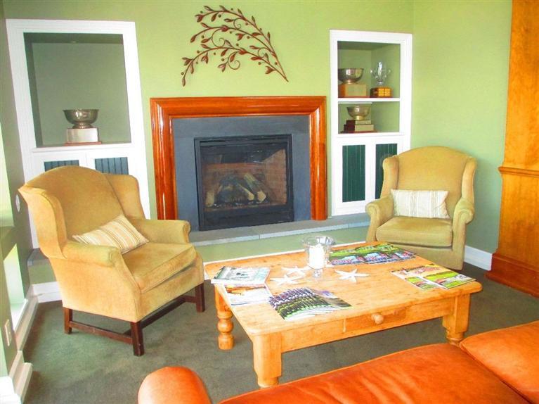 95 Cairn Ridge Road East Falmouth, MA 02536 - Photo 29 of 33 a living room with furniture rug and a fireplace