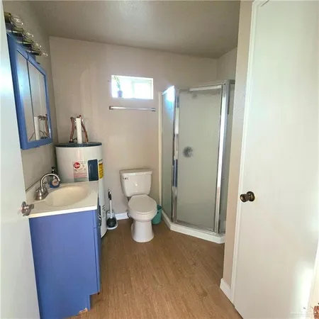 a spacious bathroom with a toilet a sink and mirror