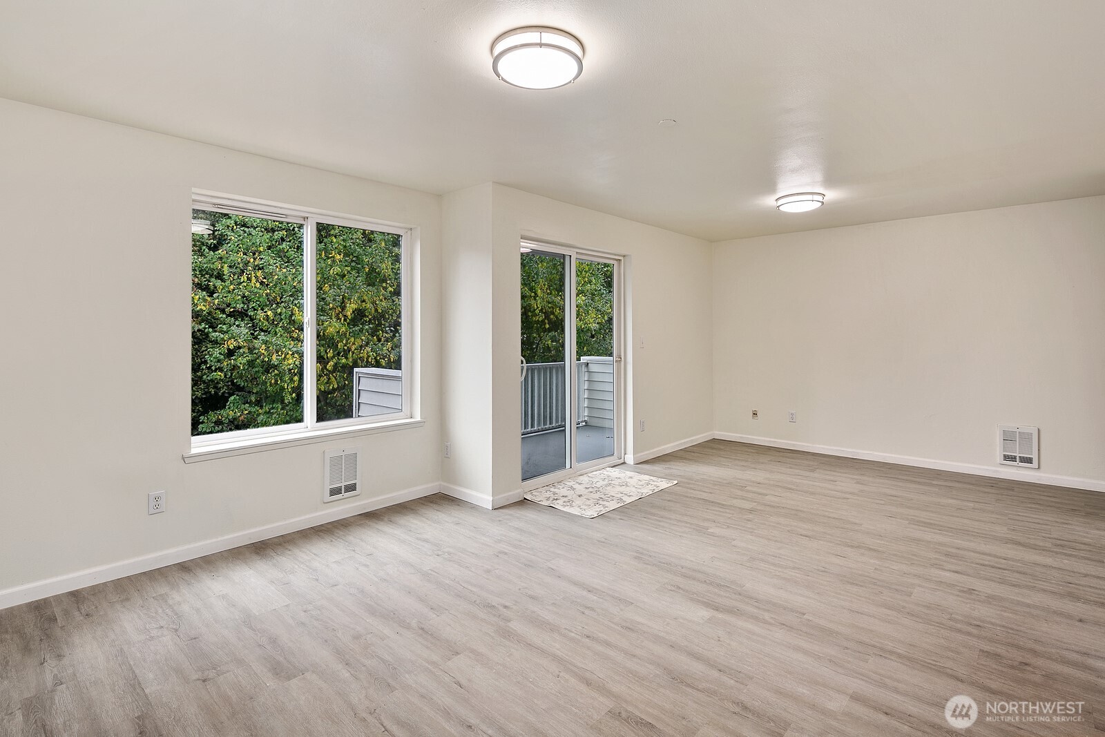 1701 16th Avenue South, Unit C Seattle, WA 98144 - Photo 14 of 27 an empty room with wooden floor and windows