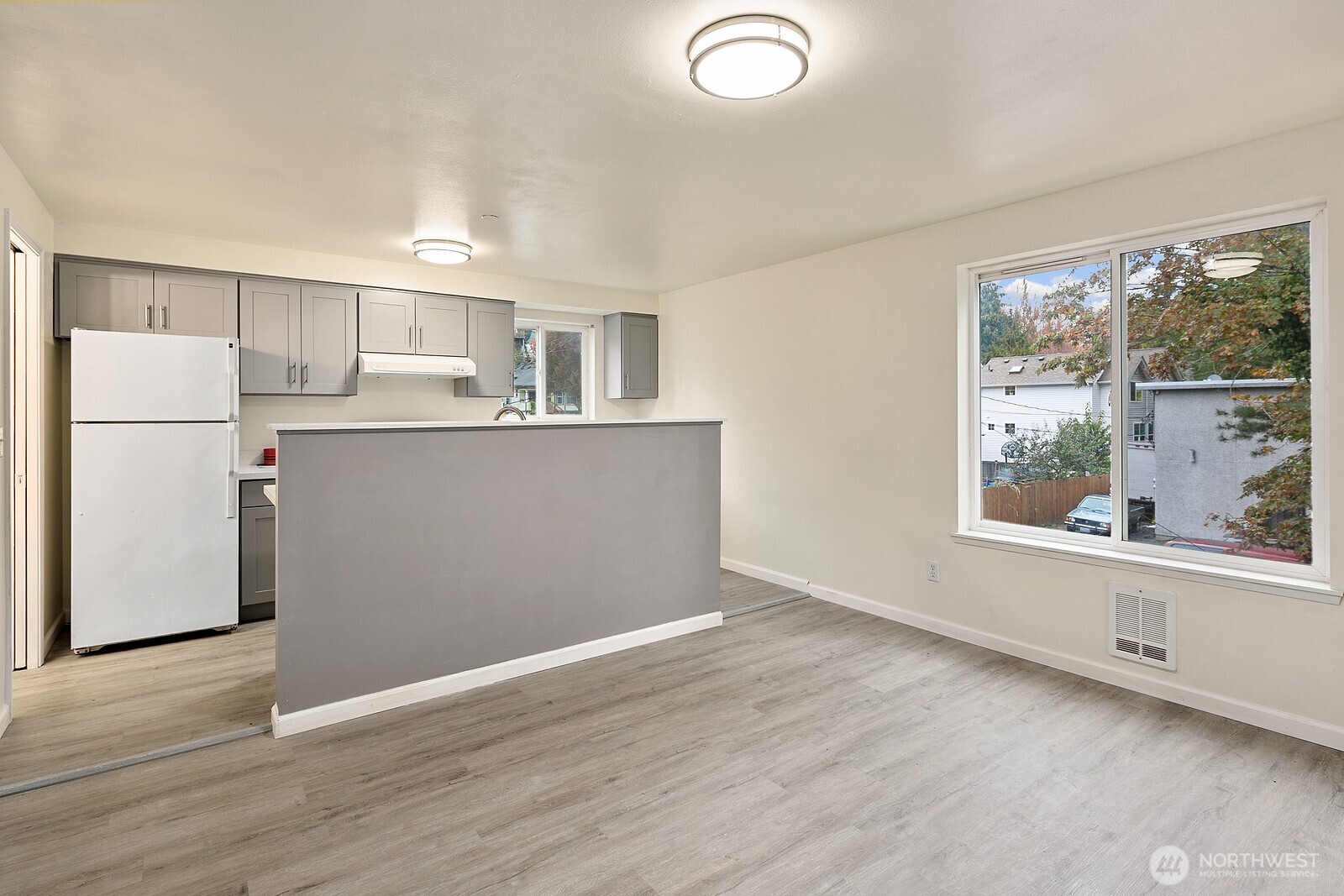 1701 16th Avenue South, Unit C Seattle, WA 98144 - Photo 15 of 27 a kitchen with a refrigerator a stove top oven and a large window