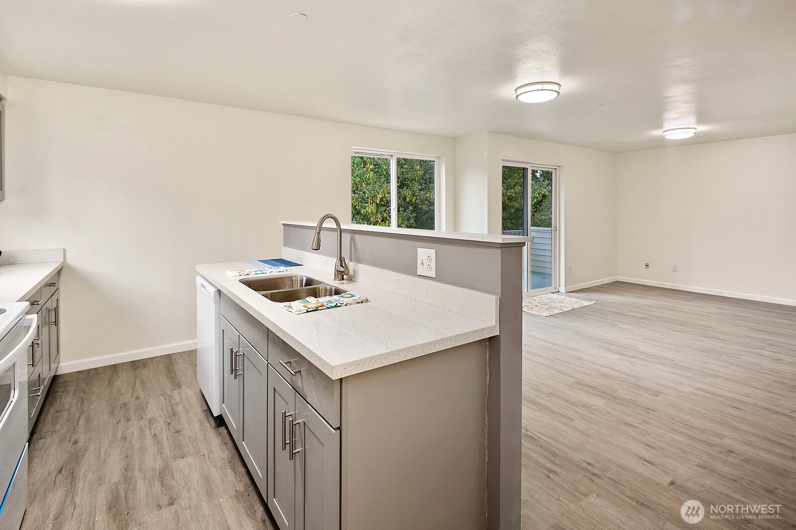 1701 16th Avenue South, Unit C Seattle, WA 98144 - Photo 18 of 27 a kitchen that has a sink and a stove with wooden floor