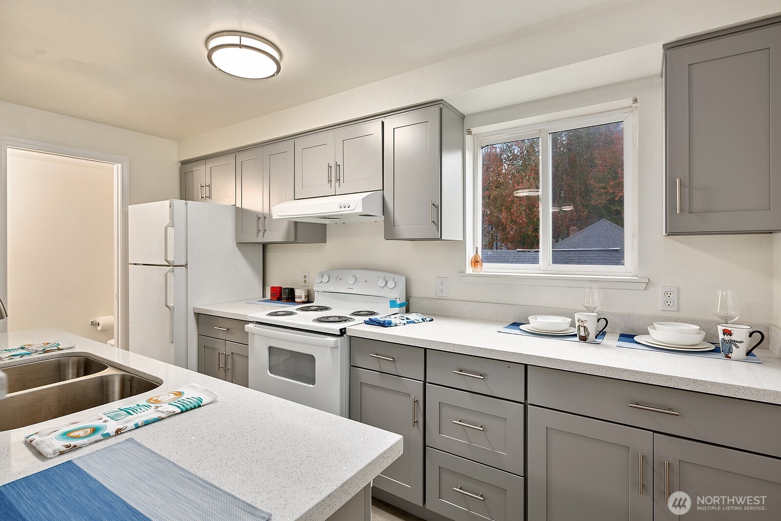 1701 16th Avenue South, Unit C Seattle, WA 98144 - Photo 19 of 27 a kitchen that has a sink a refrigerator and cabinets