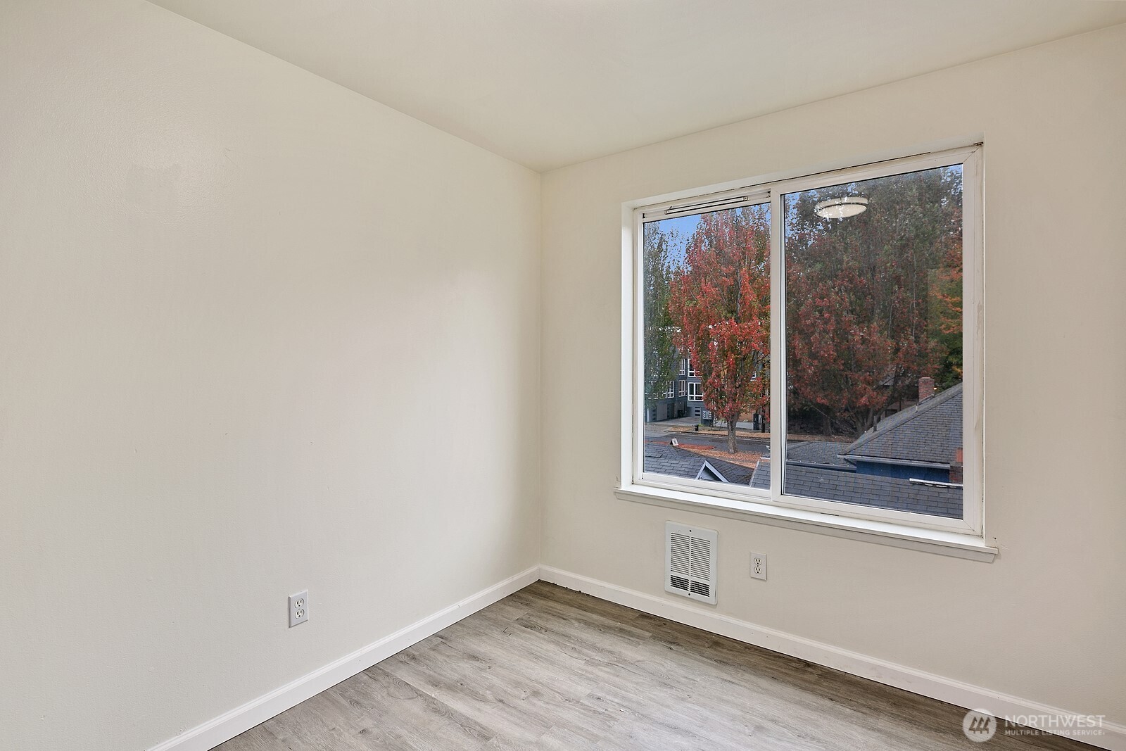 1701 16th Avenue South, Unit C Seattle, WA 98144 - Photo 21 of 27 a view of an empty room with a window and wooden floor