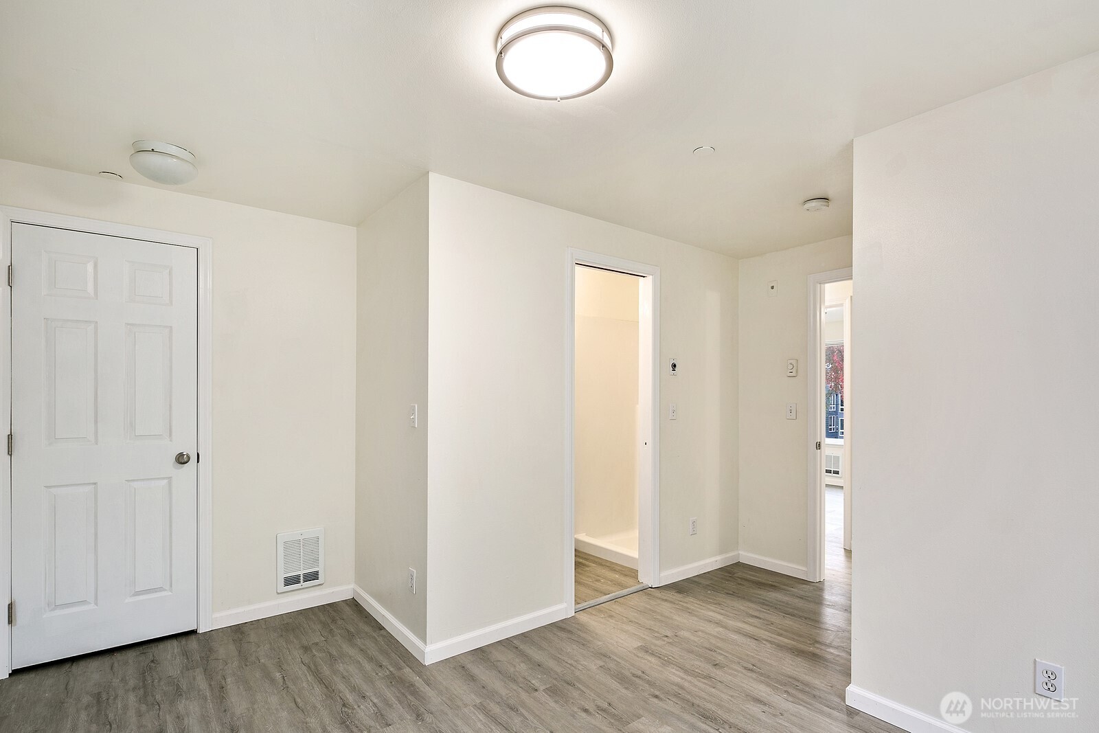 1701 16th Avenue South, Unit C Seattle, WA 98144 - Photo 25 of 27 an empty room with wooden floor and windows