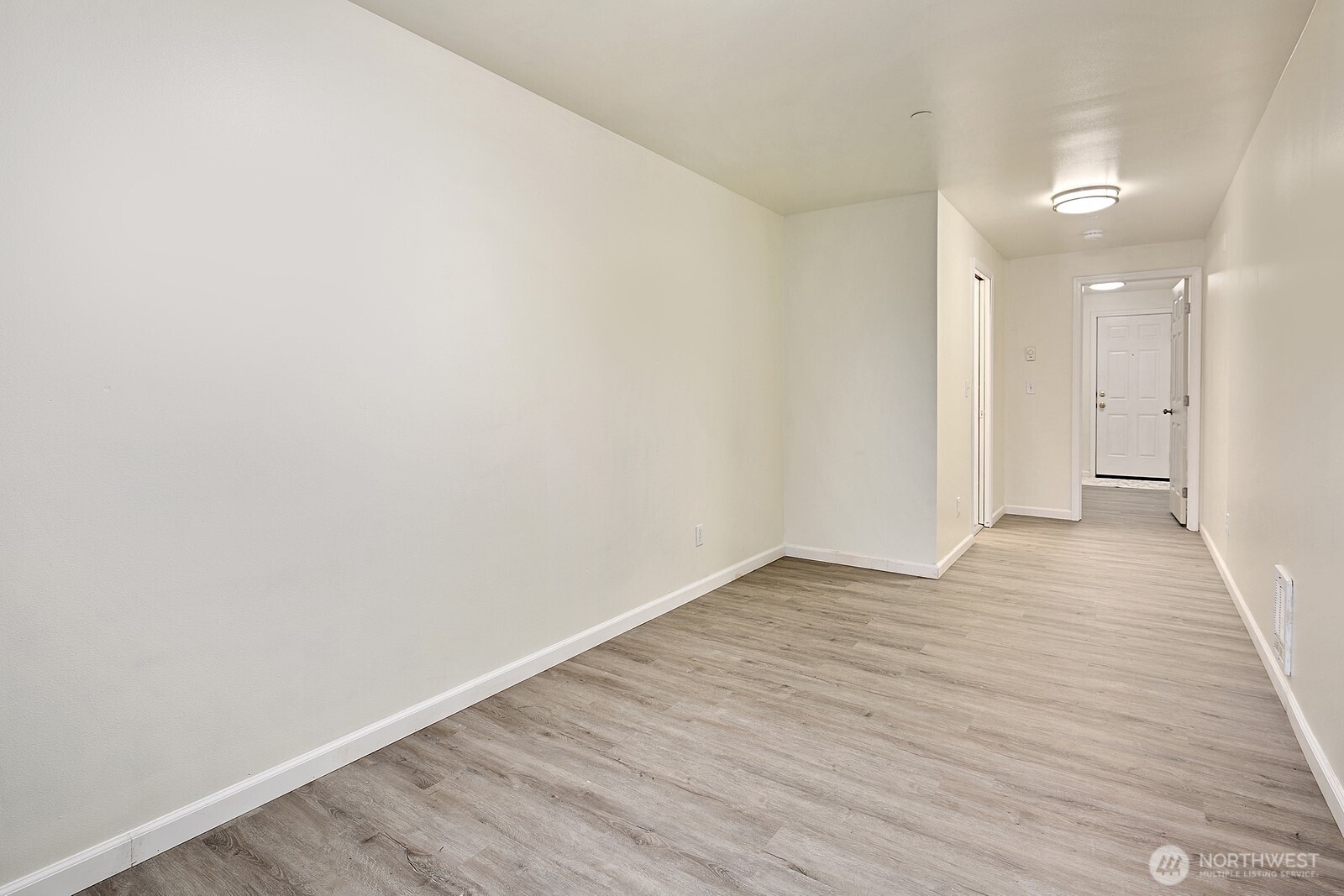 1701 16th Avenue South, Unit C Seattle, WA 98144 - Photo 4 of 27 a view of an empty room with wooden floor and a window