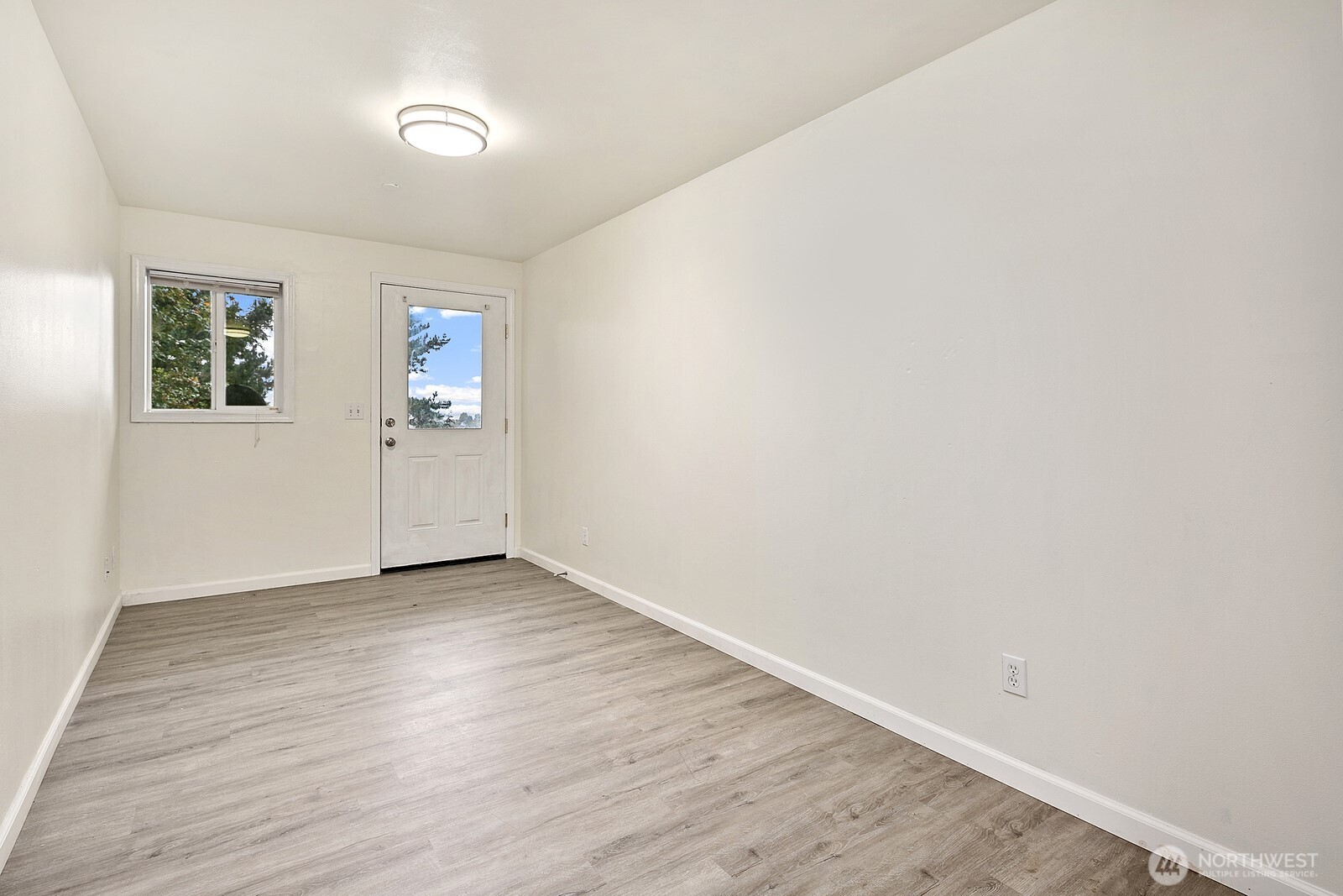 1701 16th Avenue South, Unit C Seattle, WA 98144 - Photo 5 of 27 an empty room with wooden floor and windows