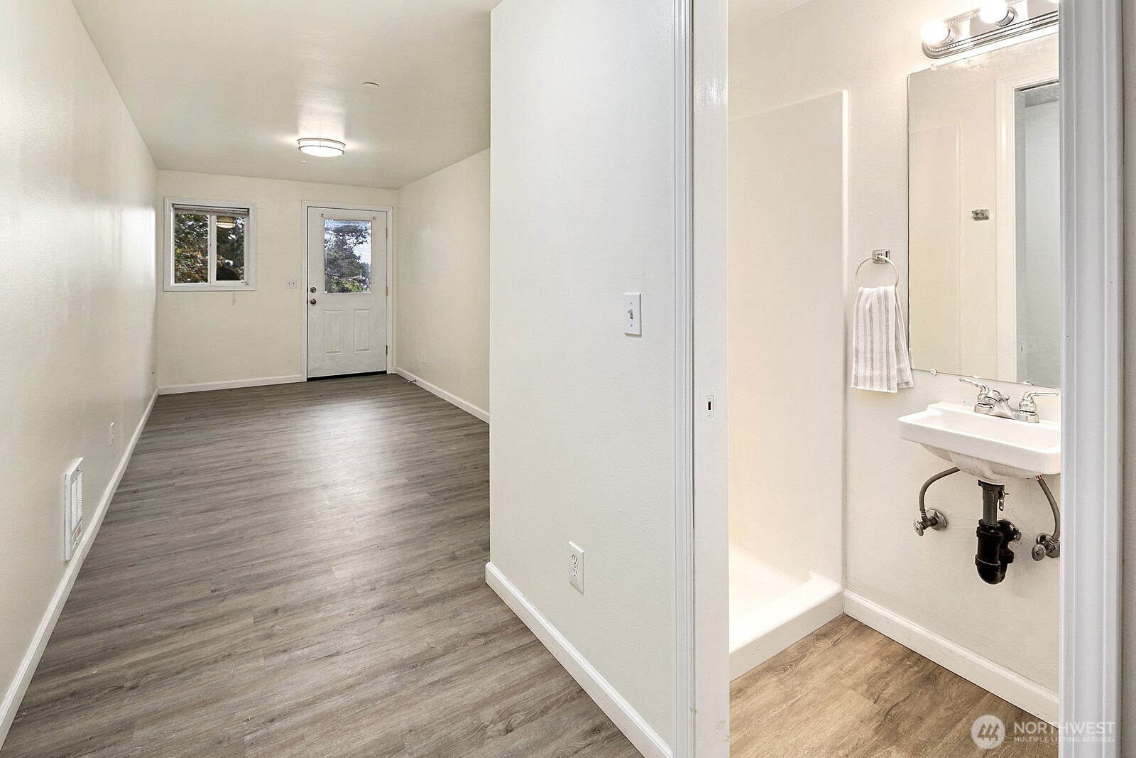 1701 16th Avenue South, Unit C Seattle, WA 98144 - Photo 7 of 27 a view of a hallway with bathroom and wooden floor