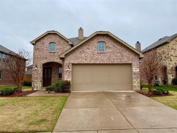 a front view of a house with yard