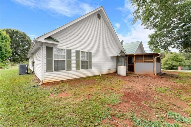 a view of a house with a backyard and a garage