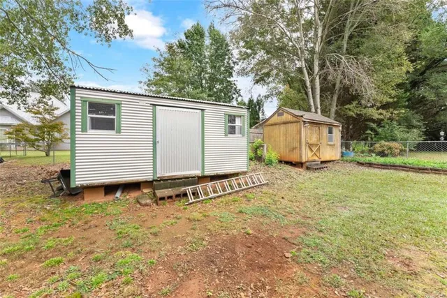 a white house that has a tree in front of it