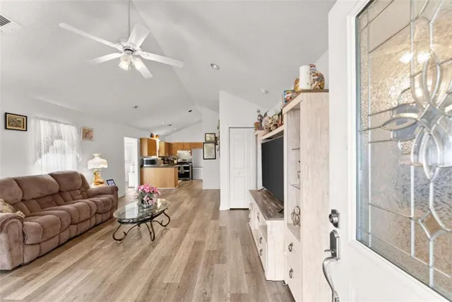 a living room with furniture and a chandelier