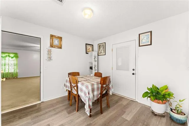 a dining room with furniture and wooden floor