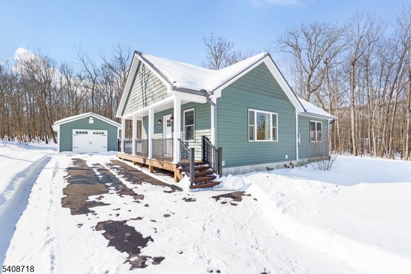 a view of a house with snow on the road