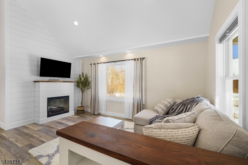 8 Worthington Road Newton, NJ 07860 - Photo 11 of 25 a living room with furniture a fireplace and a flat screen tv