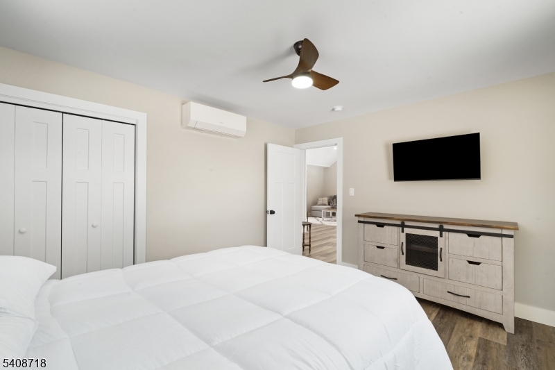 8 Worthington Road Newton, NJ 07860 - Photo 13 of 25 a bedroom with a bed and a flat tv screen on dresser