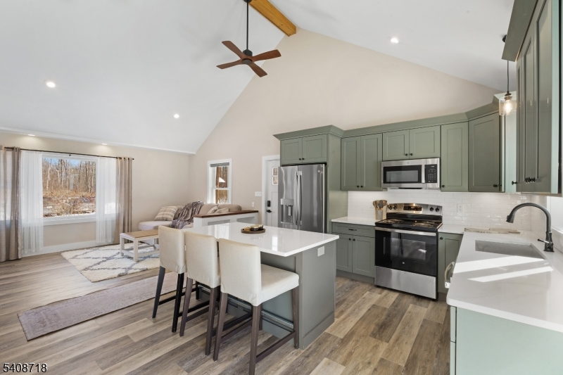 8 Worthington Road Newton, NJ 07860 - Photo 3 of 25 a kitchen with cabinets a sink stainless steel appliances and windows