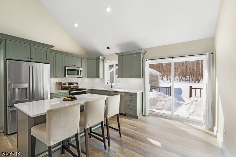 8 Worthington Road Newton, NJ 07860 - Photo 5 of 25 a kitchen with stainless steel appliances a microwave a stove a refrigerator a table and chairs