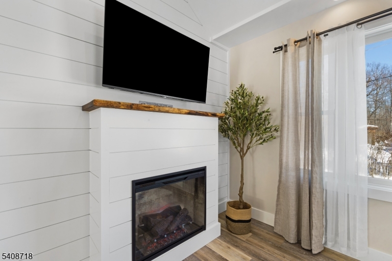 8 Worthington Road Newton, NJ 07860 - Photo 10 of 25 a living room with a fireplace and a flat screen tv