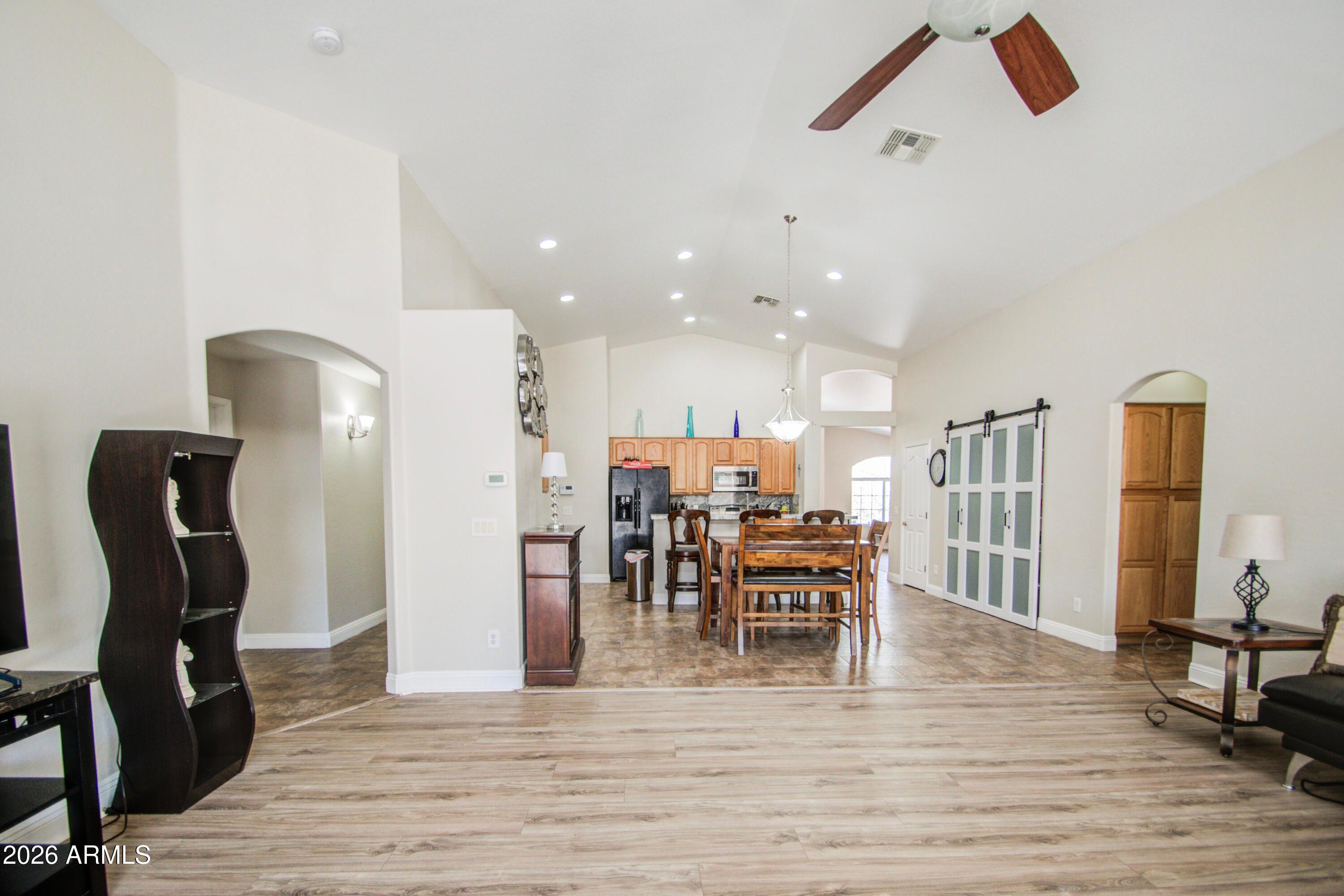 43205 Roth Road Maricopa, AZ 85138 - Photo 12 of 44 a view of a dining room with furniture and wooden floor
