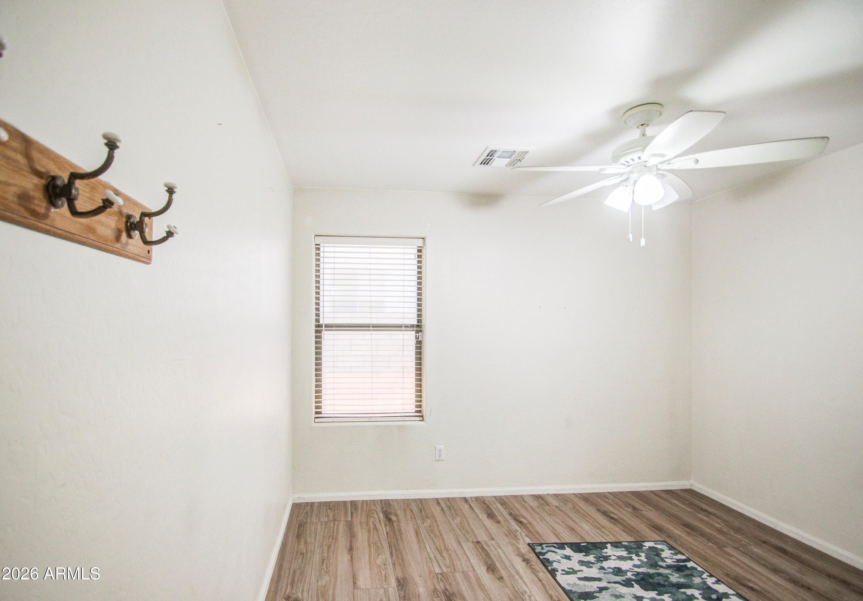 43205 Roth Road Maricopa, AZ 85138 - Photo 17 of 44 a view of a room with a ceiling fan and a window