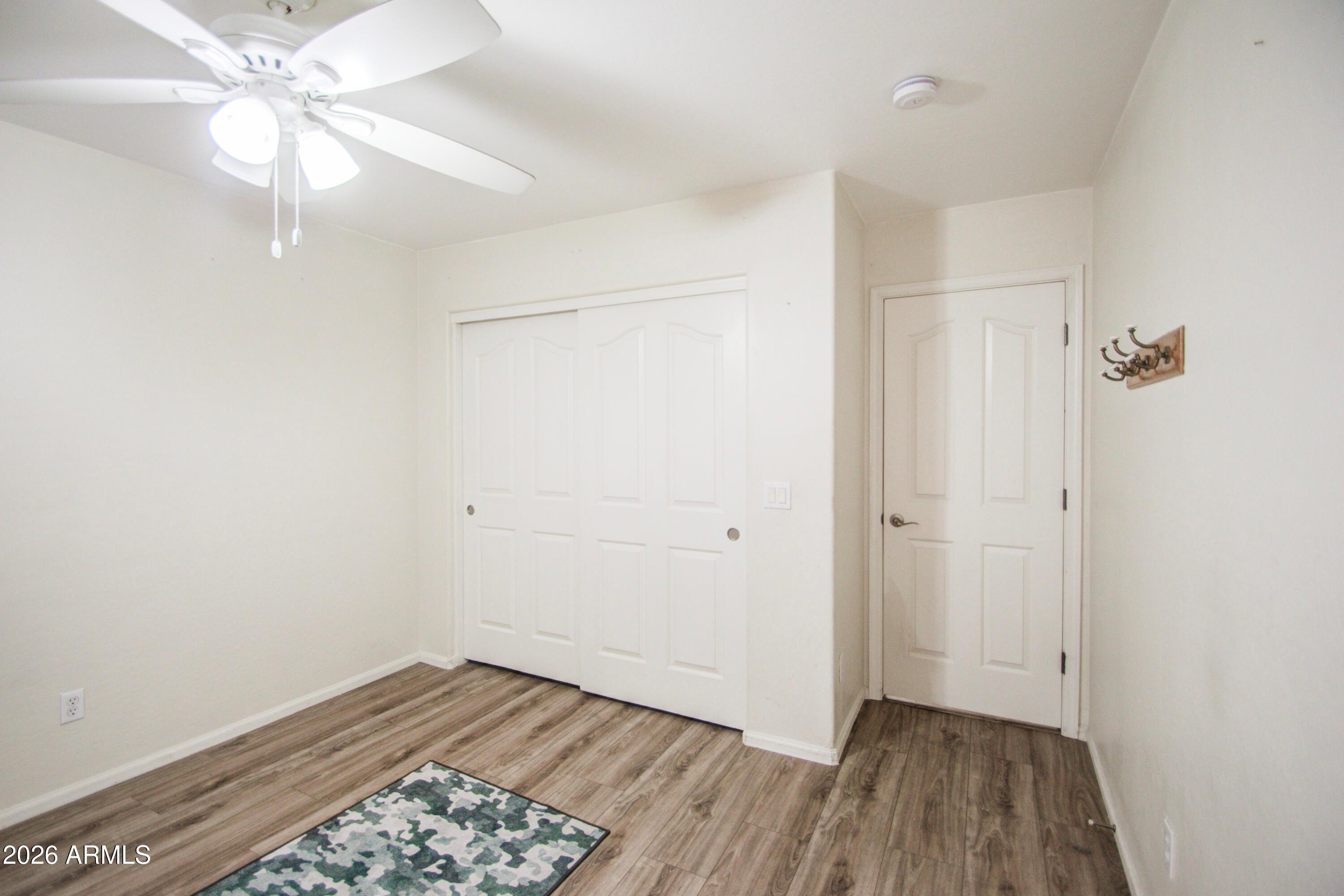 43205 Roth Road Maricopa, AZ 85138 - Photo 18 of 44 wooden floor in an empty room with a window