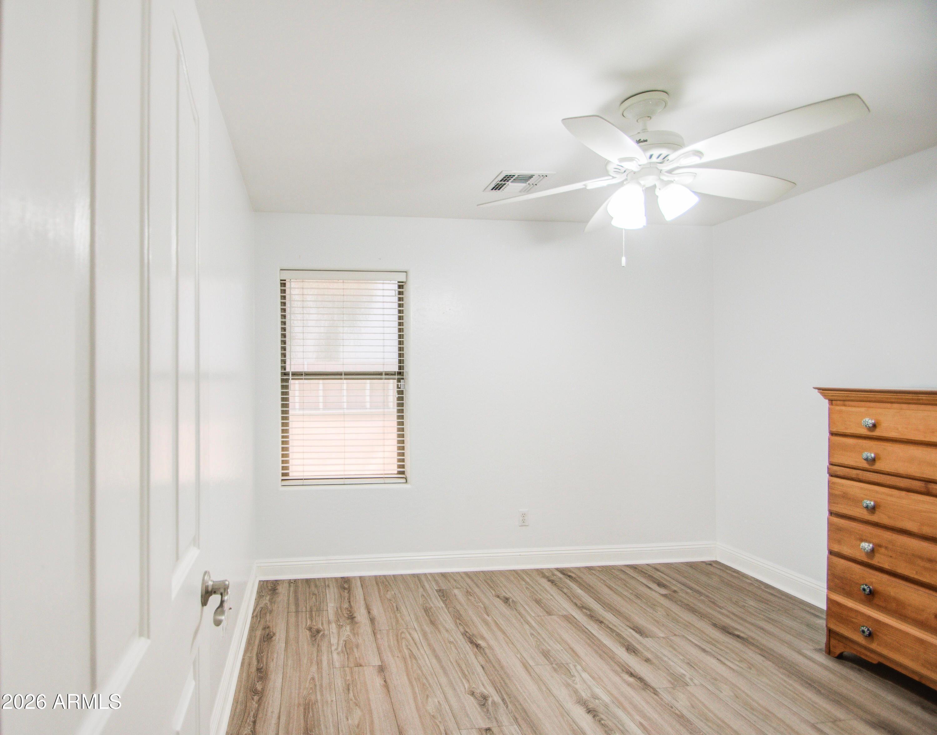 43205 Roth Road Maricopa, AZ 85138 - Photo 19 of 44 wooden floor in an empty room with a window