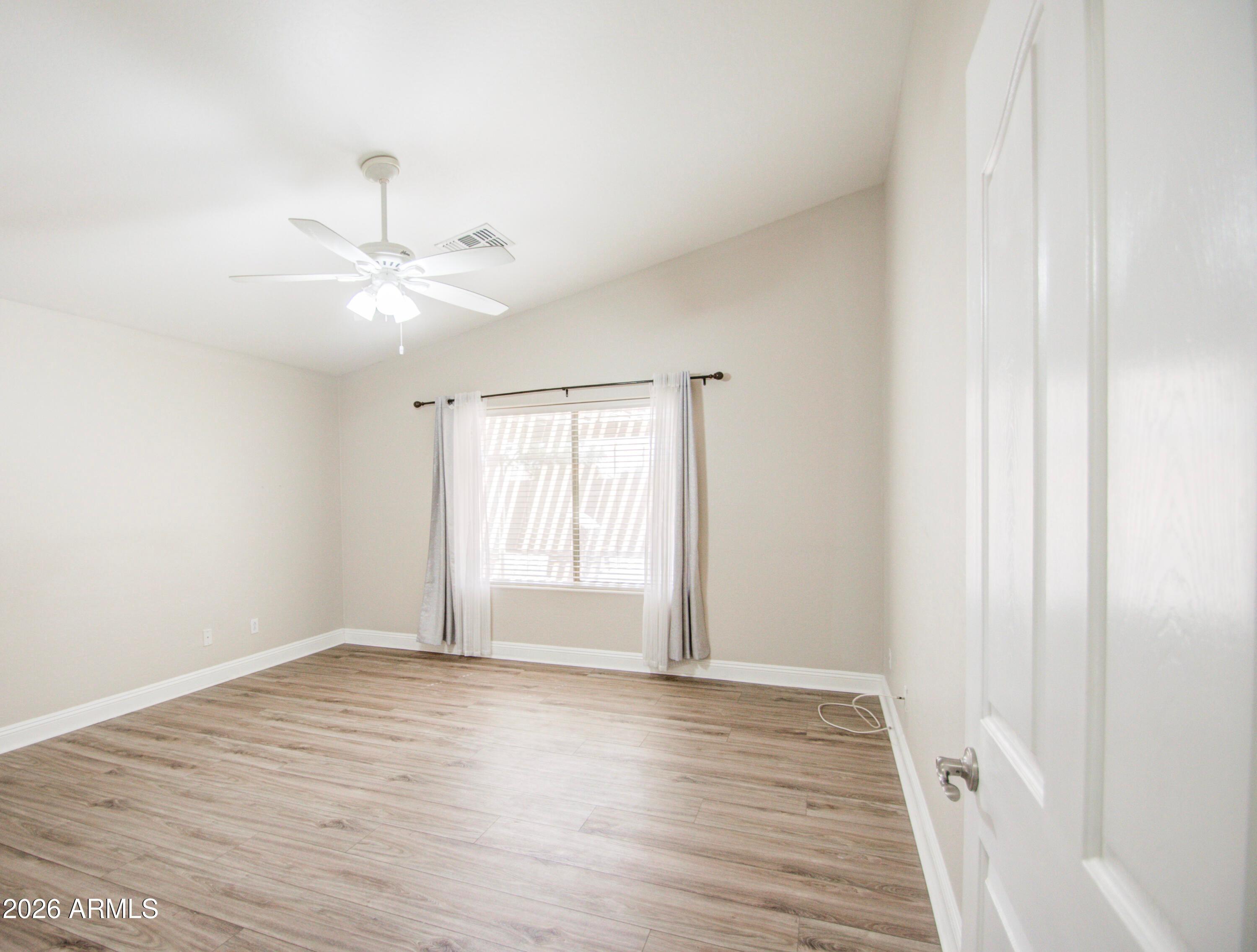 43205 Roth Road Maricopa, AZ 85138 - Photo 24 of 44 a view of an empty room with wooden floor