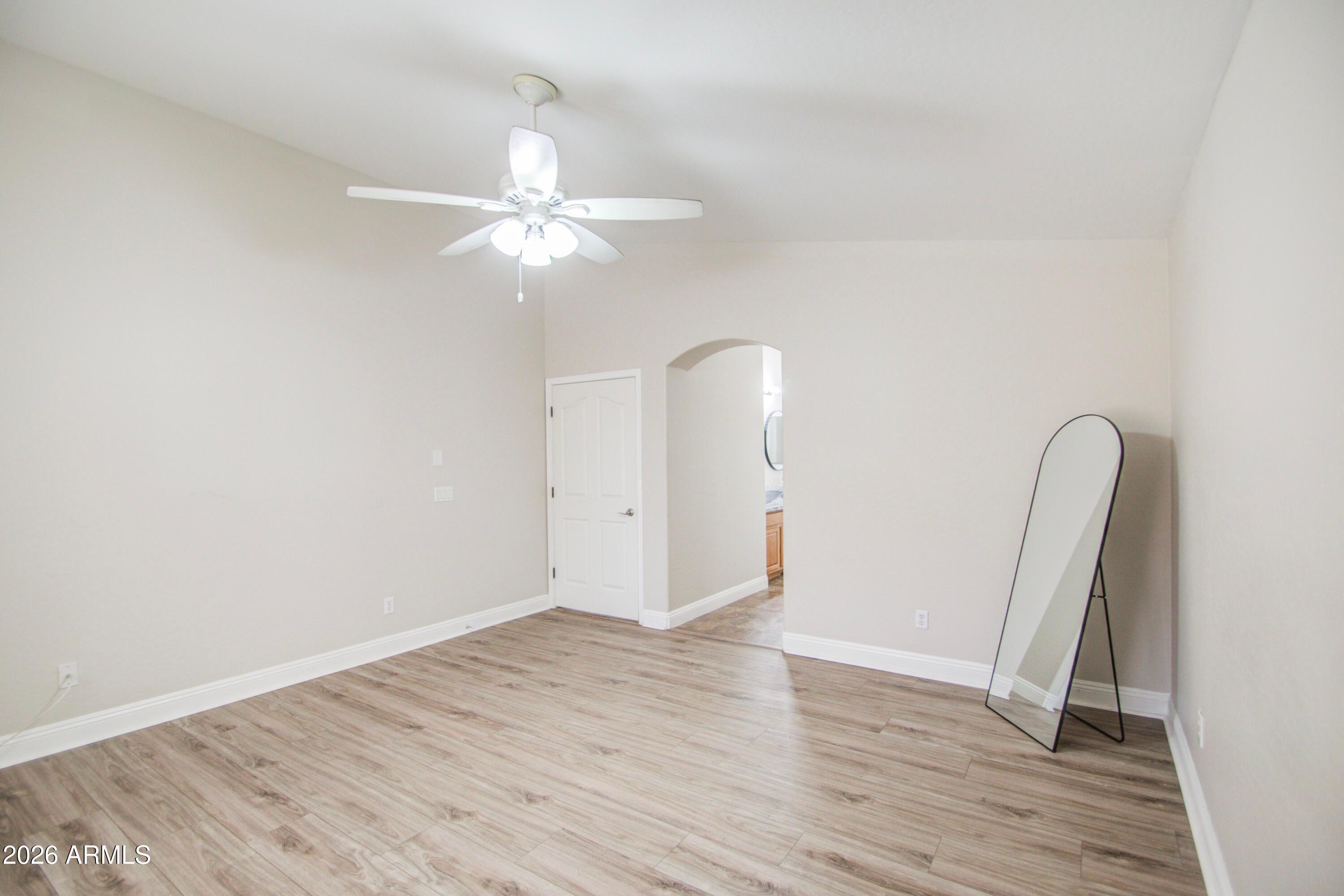 43205 Roth Road Maricopa, AZ 85138 - Photo 25 of 44 wooden floor in an empty room with a window