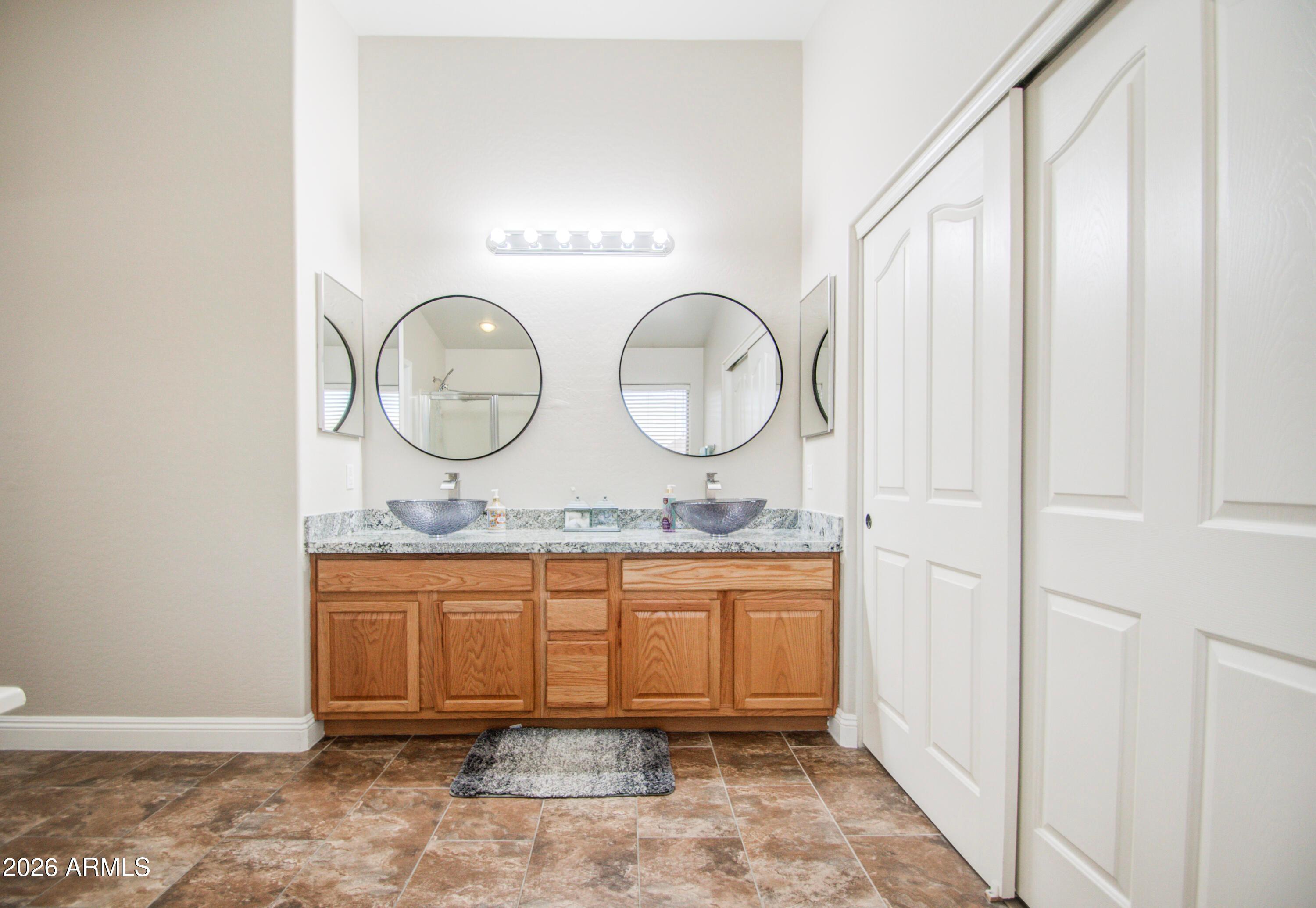 43205 Roth Road Maricopa, AZ 85138 - Photo 28 of 44 a bathroom with mirror and vanity