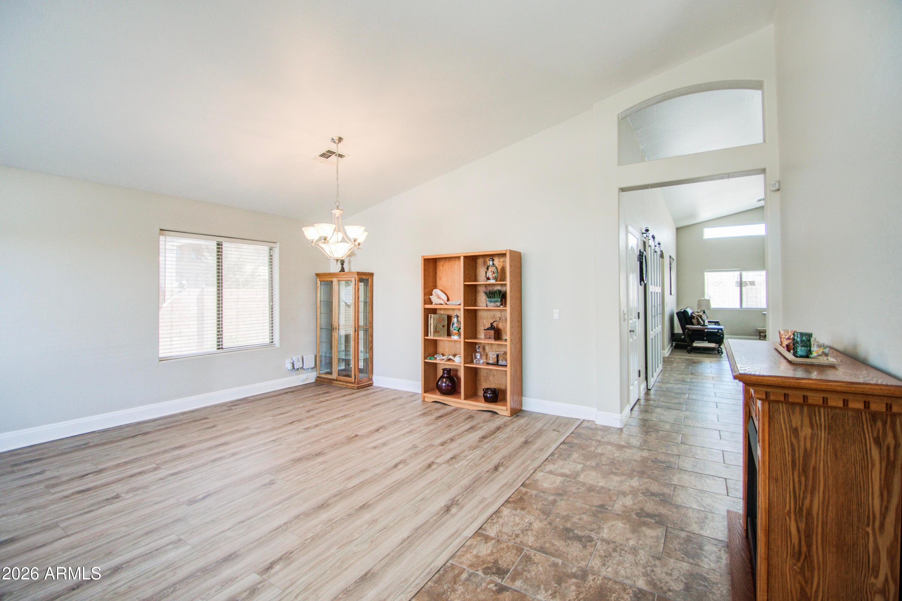 43205 Roth Road Maricopa, AZ 85138 - Photo 3 of 44 wooden floor in an empty room with a window