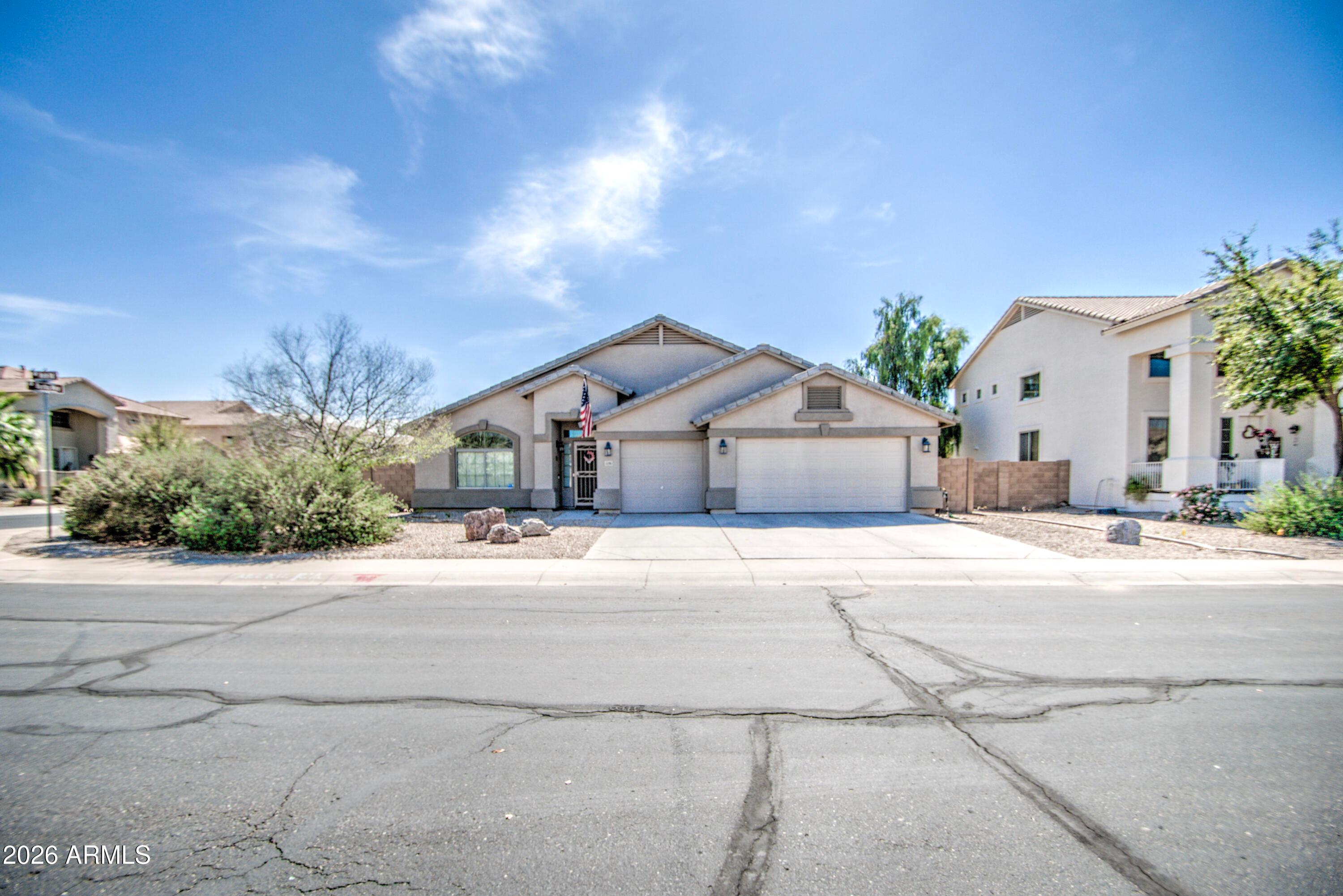 43205 Roth Road Maricopa, AZ 85138 - Photo 43 of 44 a front view of a house with a yard and garage