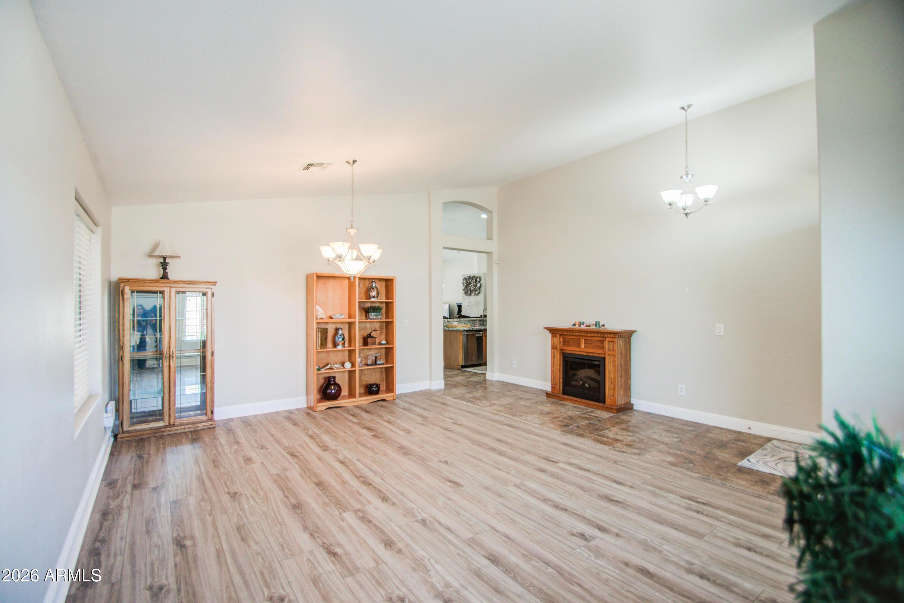 43205 Roth Road Maricopa, AZ 85138 - Photo 5 of 44 a view of empty room with wooden floor