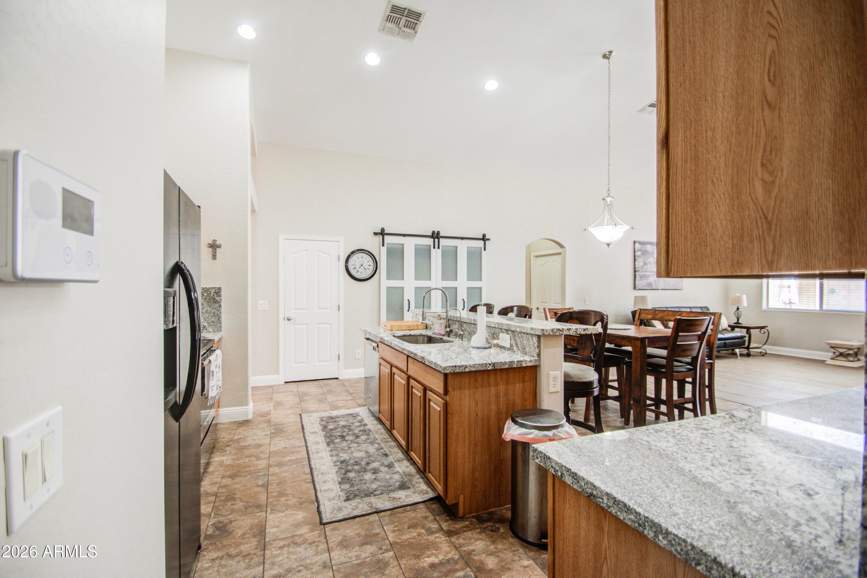 43205 Roth Road Maricopa, AZ 85138 - Photo 7 of 44 a large kitchen with lots of counter space and stainless steel appliances