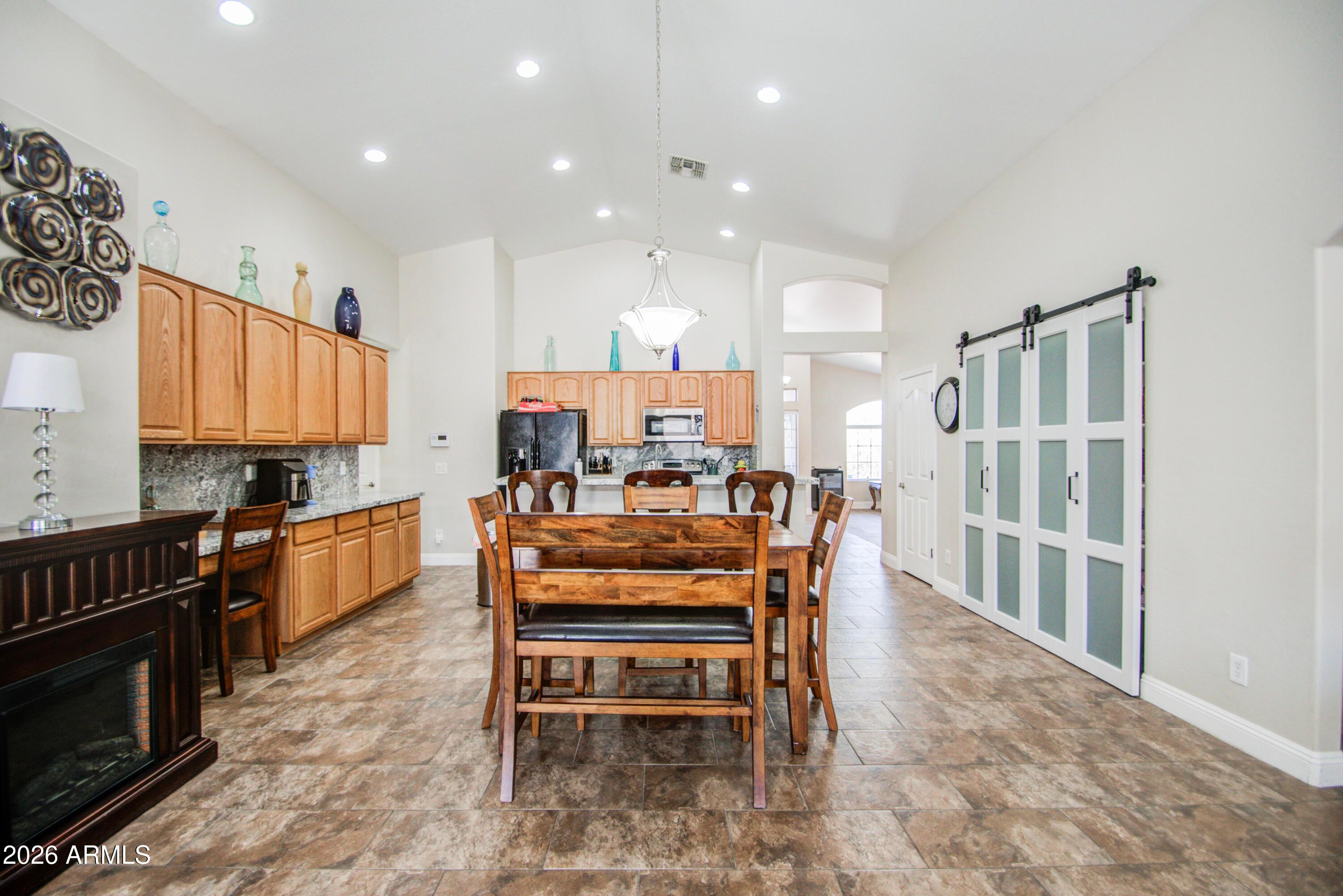 43205 Roth Road Maricopa, AZ 85138 - Photo 8 of 44 a kitchen with stainless steel appliances kitchen island granite countertop a refrigerator and a stove top oven