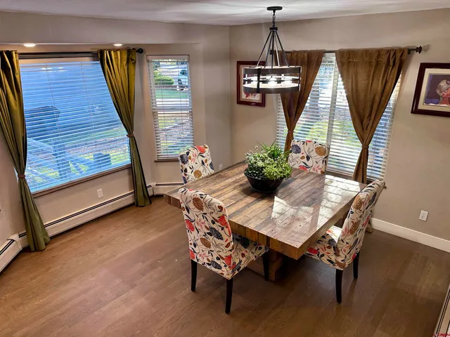 a dining room with furniture and window