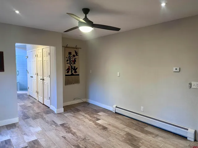 an empty room with closet and windows