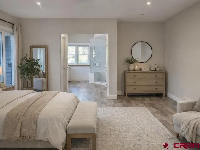 a bathroom with a granite countertop sink a toilet and shower
