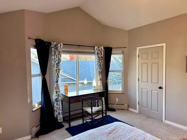 a bedroom with furniture and a window