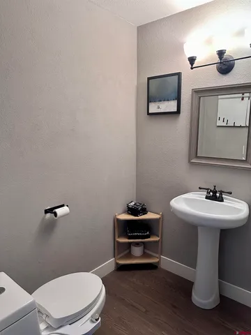 a bathroom with a sink a toilet and mirror