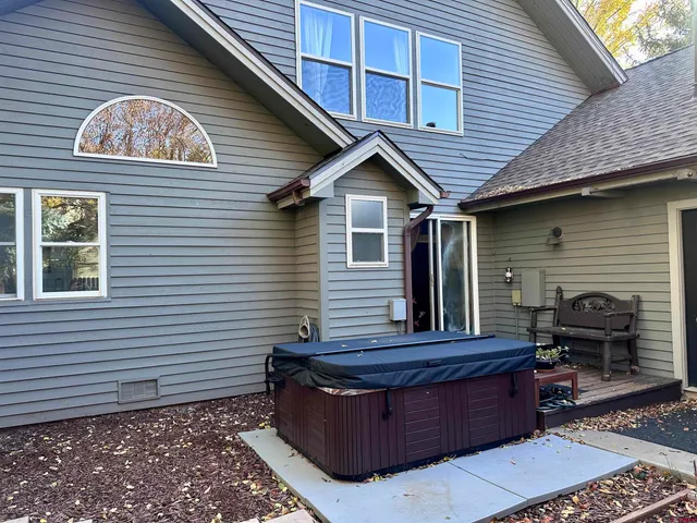 a view of water heater room with wooden floor