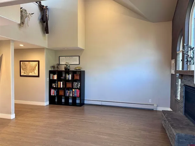 an empty room with bookshelf and a window