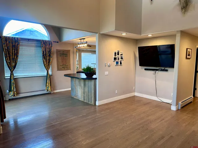 a view of an empty room with workspace and a window